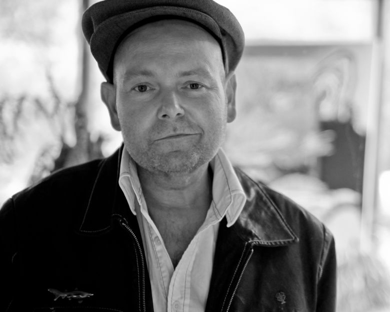 Artist Adam Cullen in a black jacket and black cap